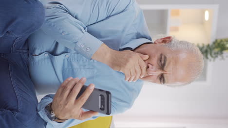 Vertical-video-of-The-old-man-on-the-phone.